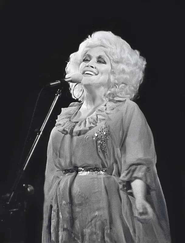 Dolly Parton performing onstage with a microphone