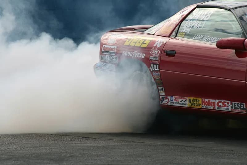 Chris 'Block' Gordon standing beside his 1979 Ford Fairmont drag car at a Street Outlaws event